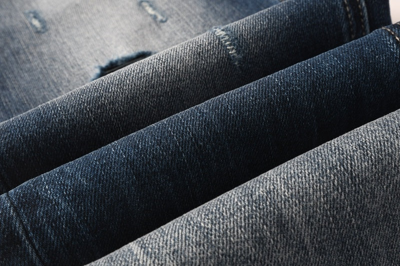 KSUBI denim dark blue lightly distressed skinny jeans with white writing