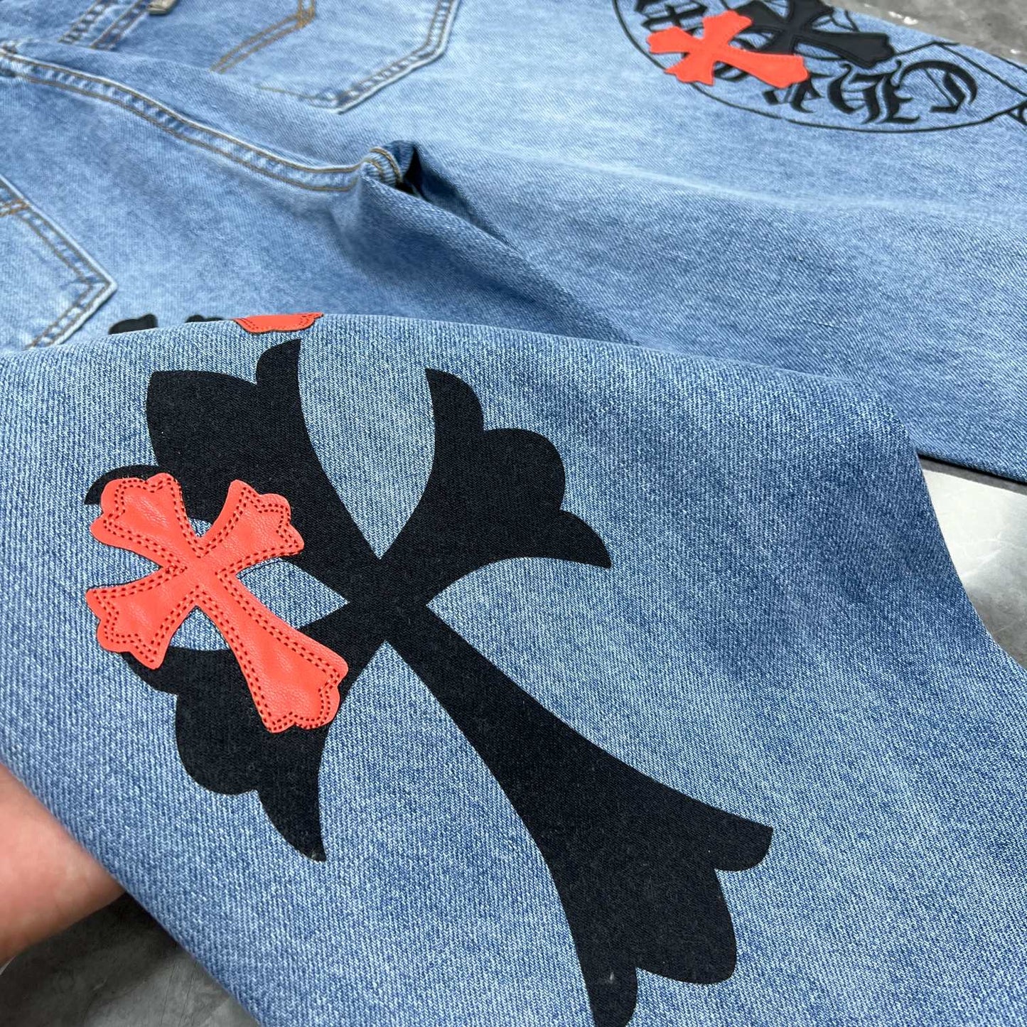 Chrome hearts jeans with black and red crosses