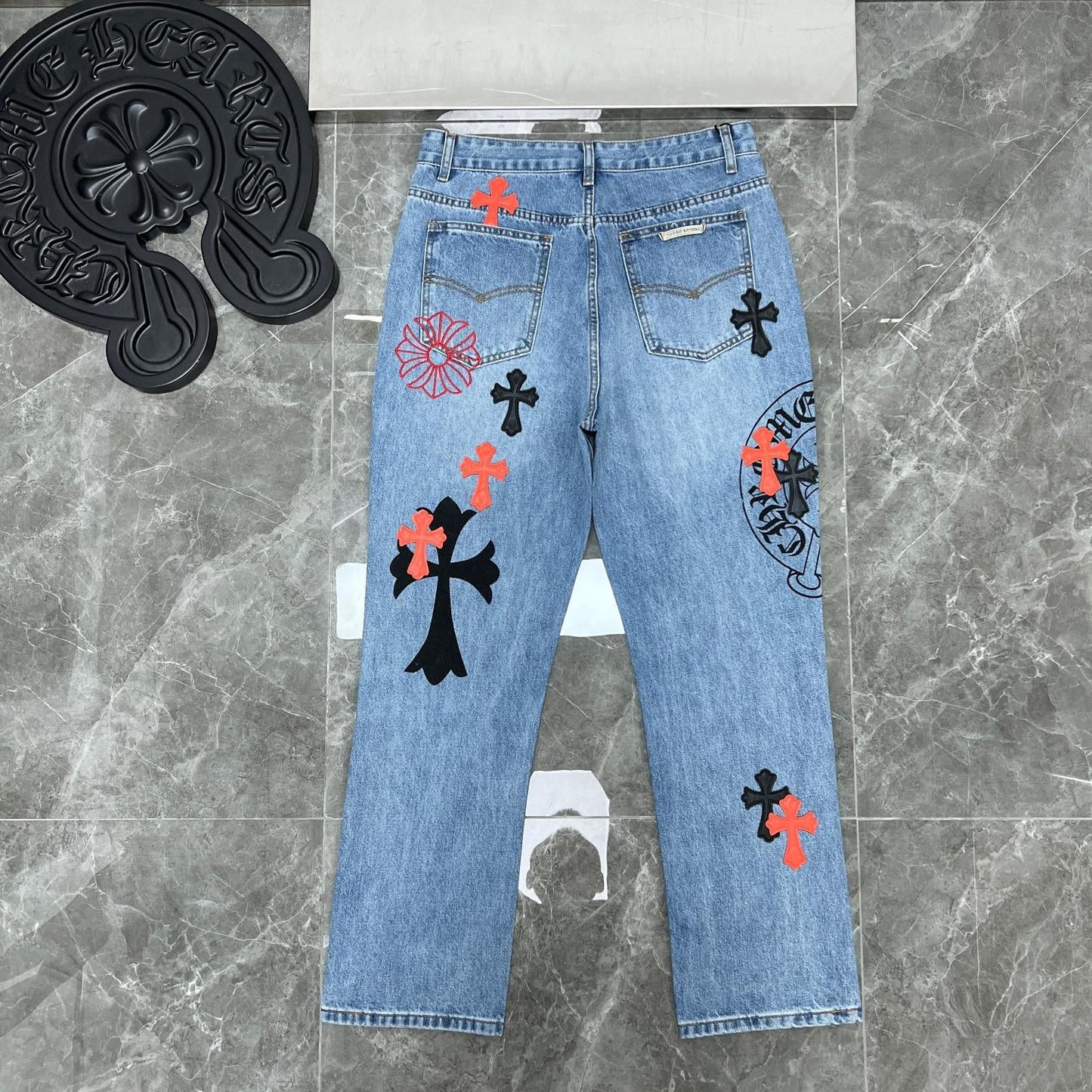 Chrome hearts jeans with black and red crosses