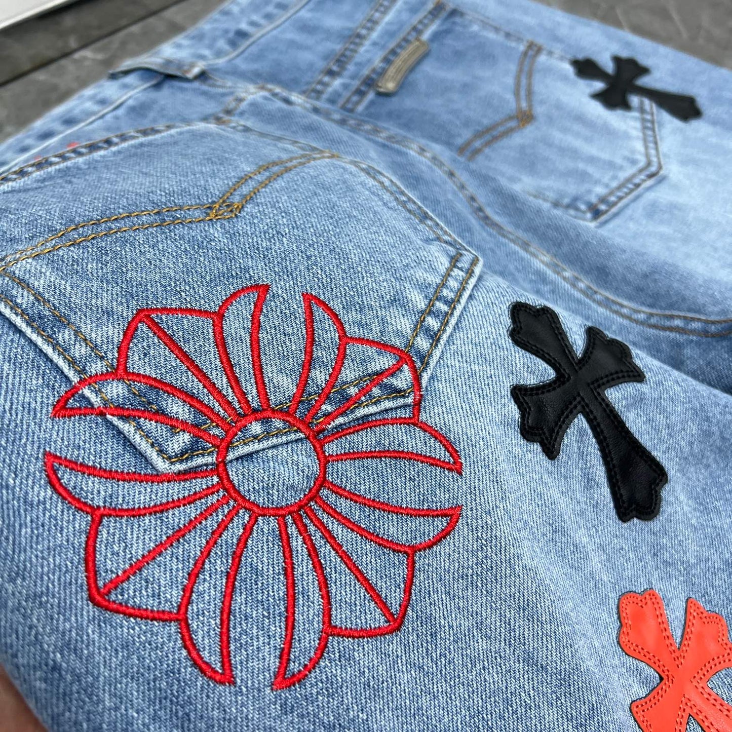 Chrome hearts jeans with black and red crosses