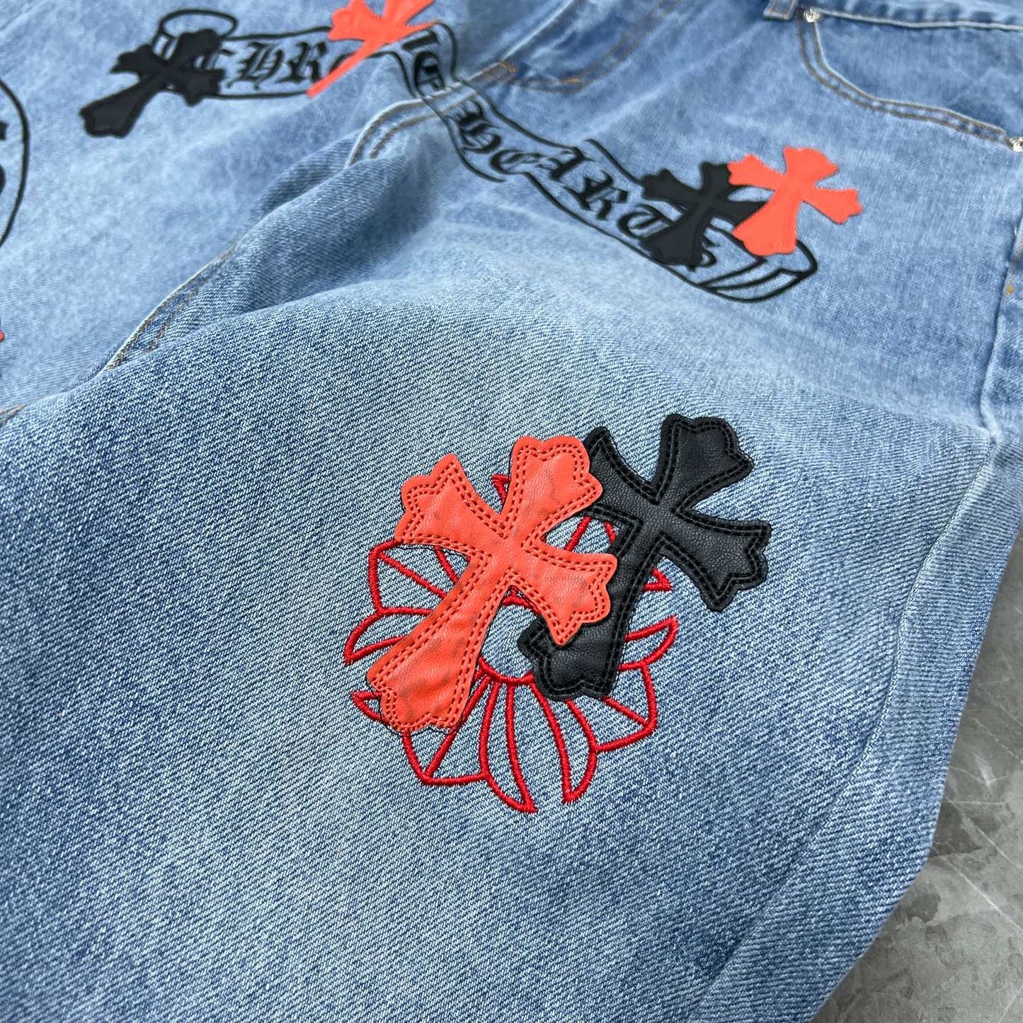 Chrome hearts jeans with black and red crosses