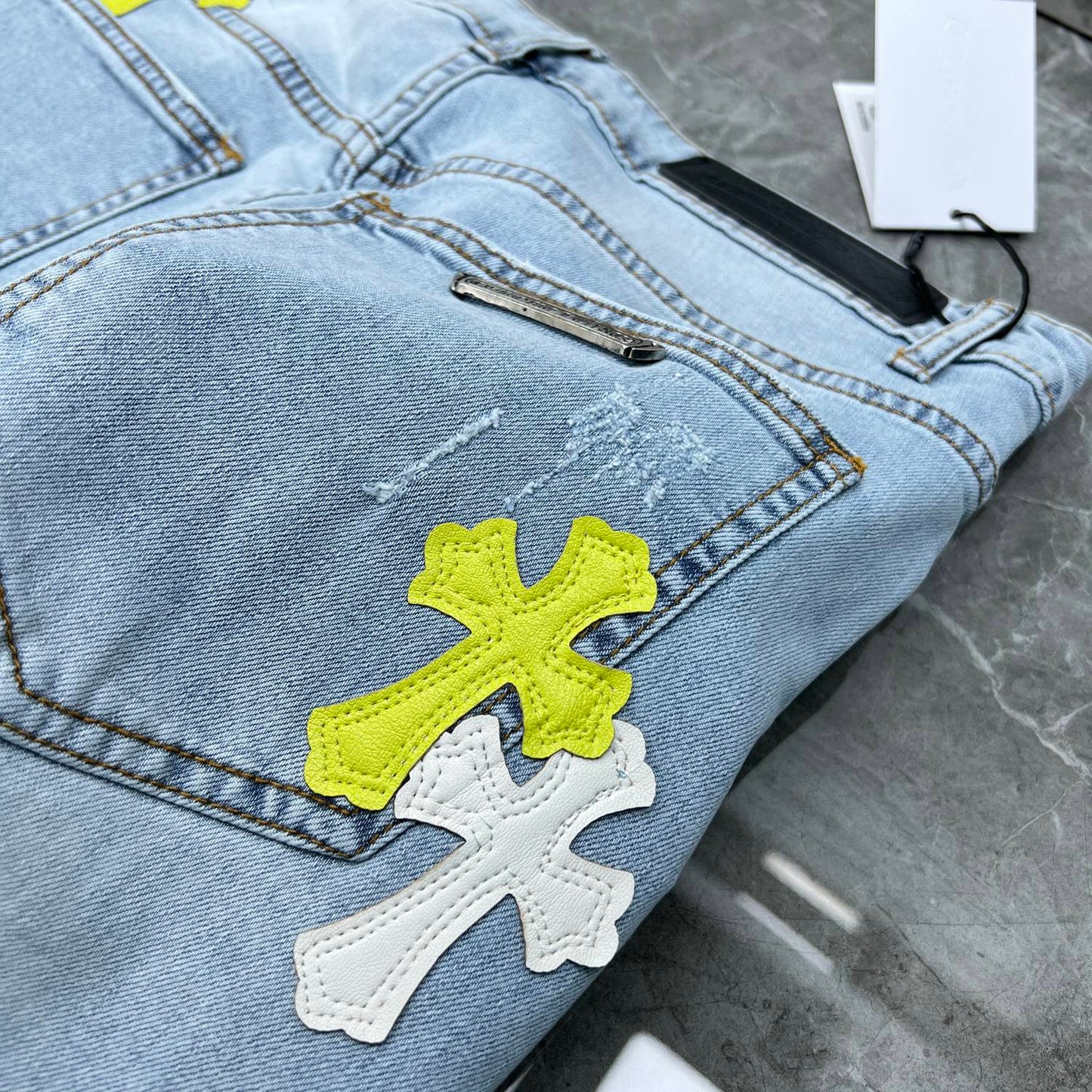 Chrome hearts jorts with blue and yellow crosses