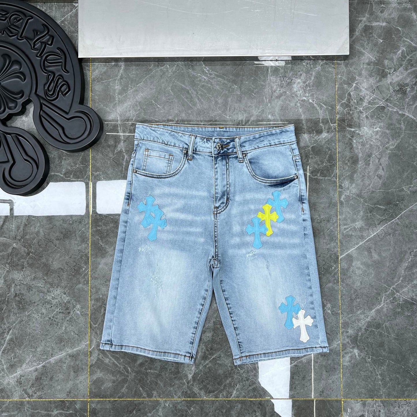 Chrome hearts jorts with blue and yellow crosses