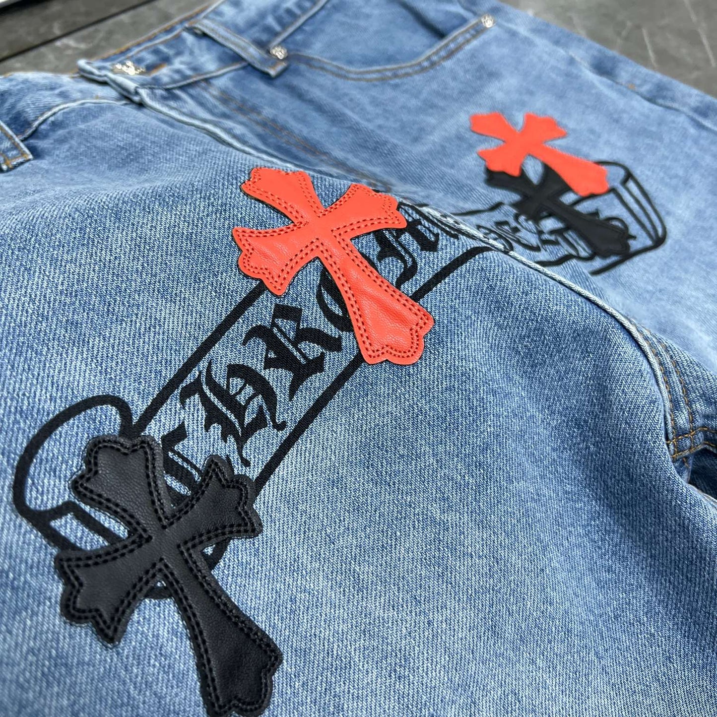 Chrome hearts jeans with black and red crosses