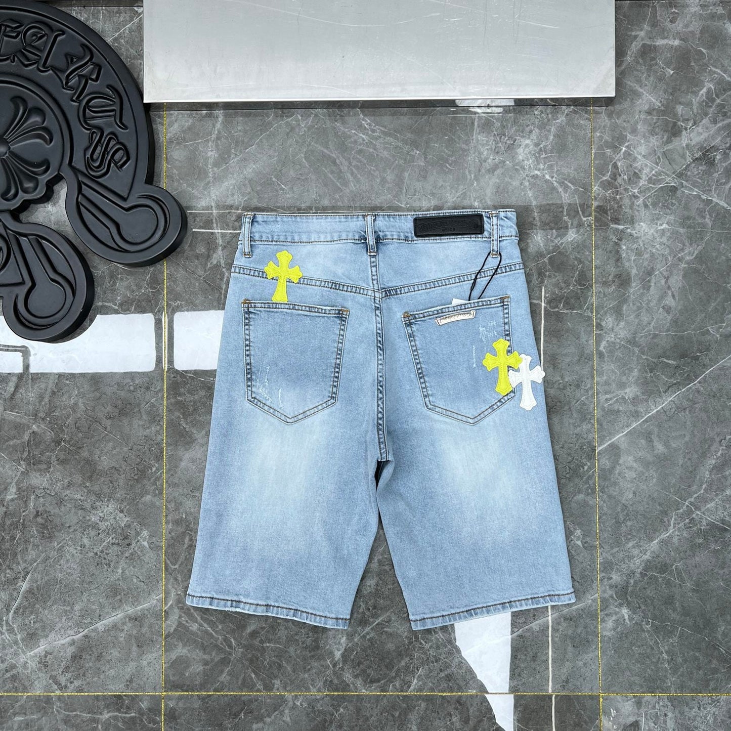 Chrome hearts jorts with blue and yellow crosses