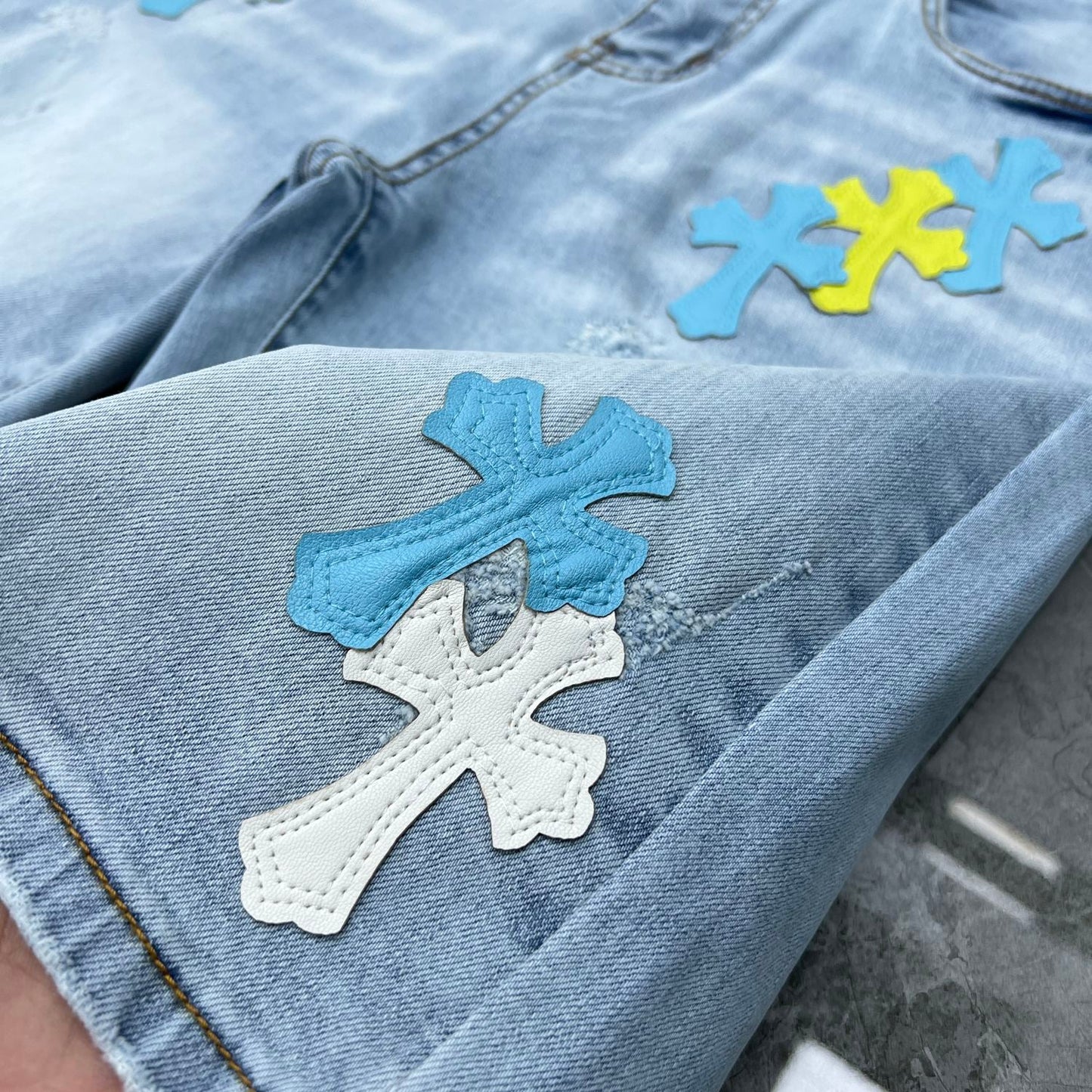 Chrome hearts jorts with blue and yellow crosses